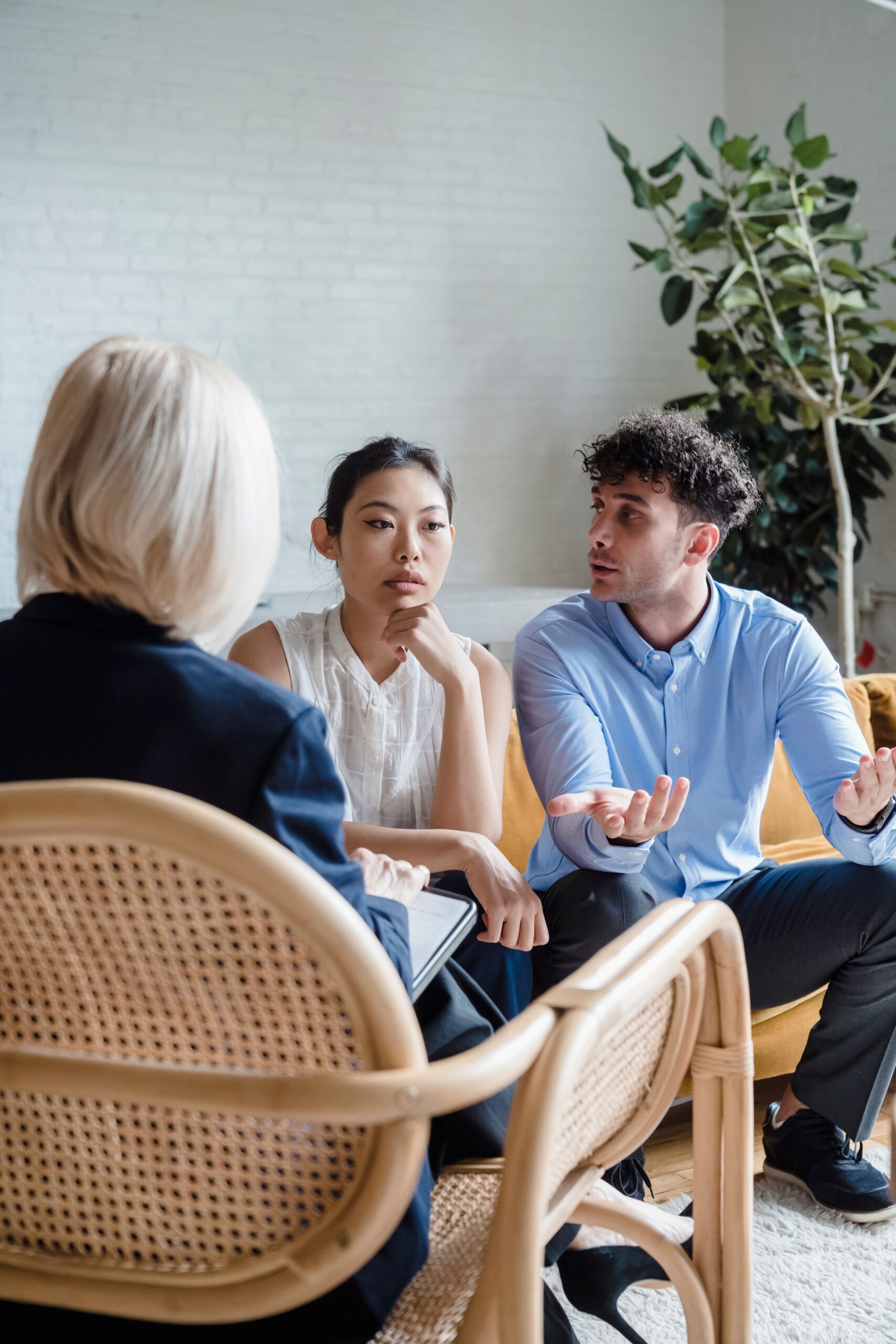 Couple discussing relationship issues with a therapist in a modern office