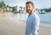 Person standing confidently outdoors without performing an alpha male persona