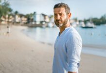 Person standing confidently outdoors without performing an alpha male persona