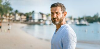 Person standing confidently outdoors without performing an alpha male persona