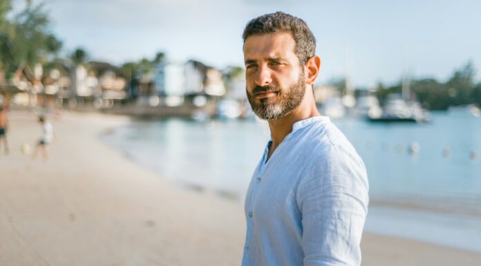 Person standing confidently outdoors without performing an alpha male persona