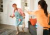 Couple cleaning their home together while sharing household chores