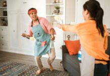 How to Divide Household Chores Without Resentment Couple cleaning their home together while sharing household chores