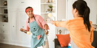 Couple cleaning their home together while sharing household chores