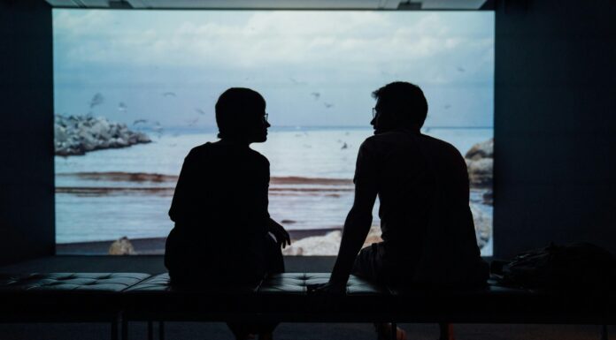 Couple sitting in silence while experiencing emotional distance