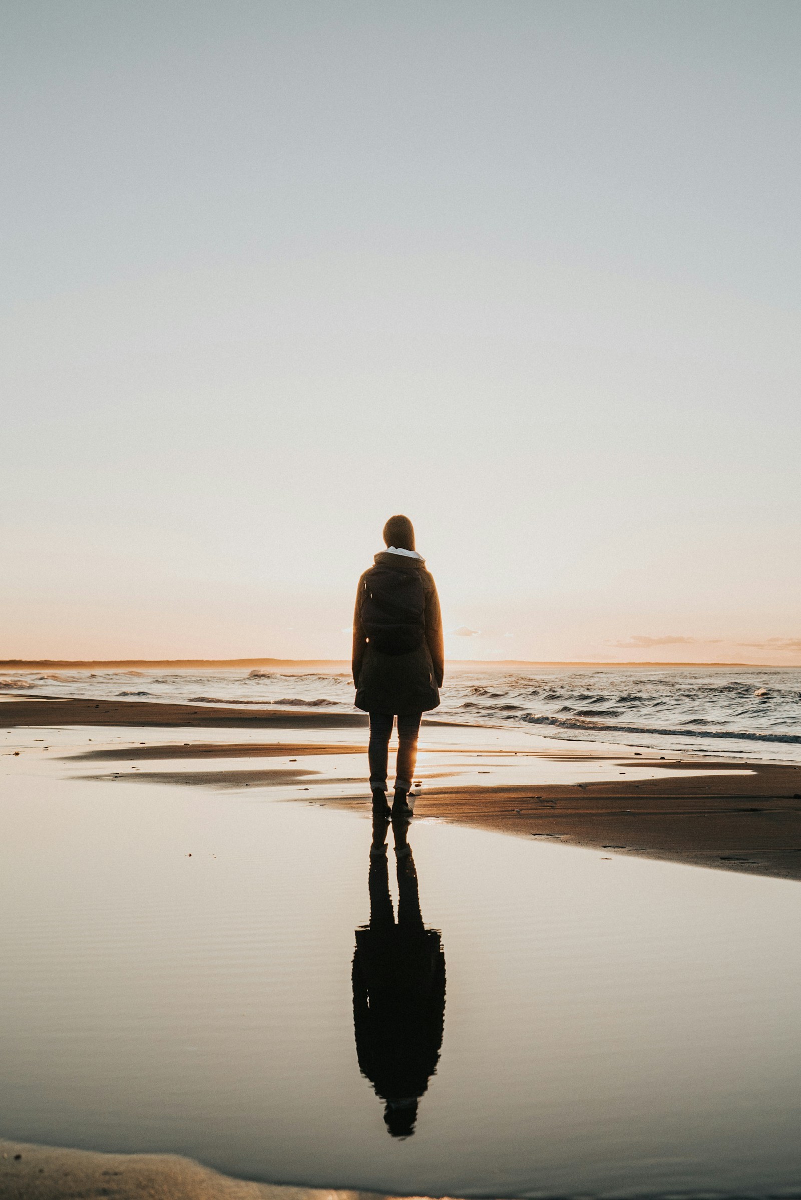 Person reflecting by the shoreline after a relationship ends