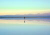 Person reflecting near the water during the first month after a breakup