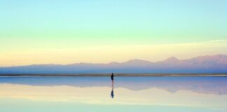 Person reflecting near the water during the first month after a breakup