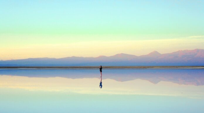 Person reflecting near the water during the first month after a breakup