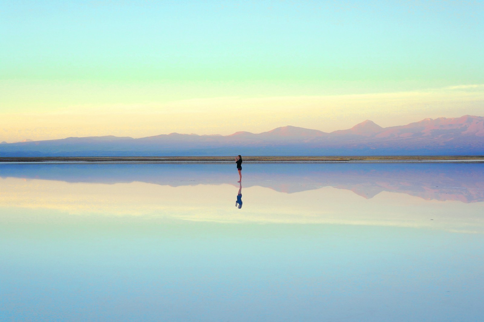 Person reflecting near the water during the first month after a breakup
