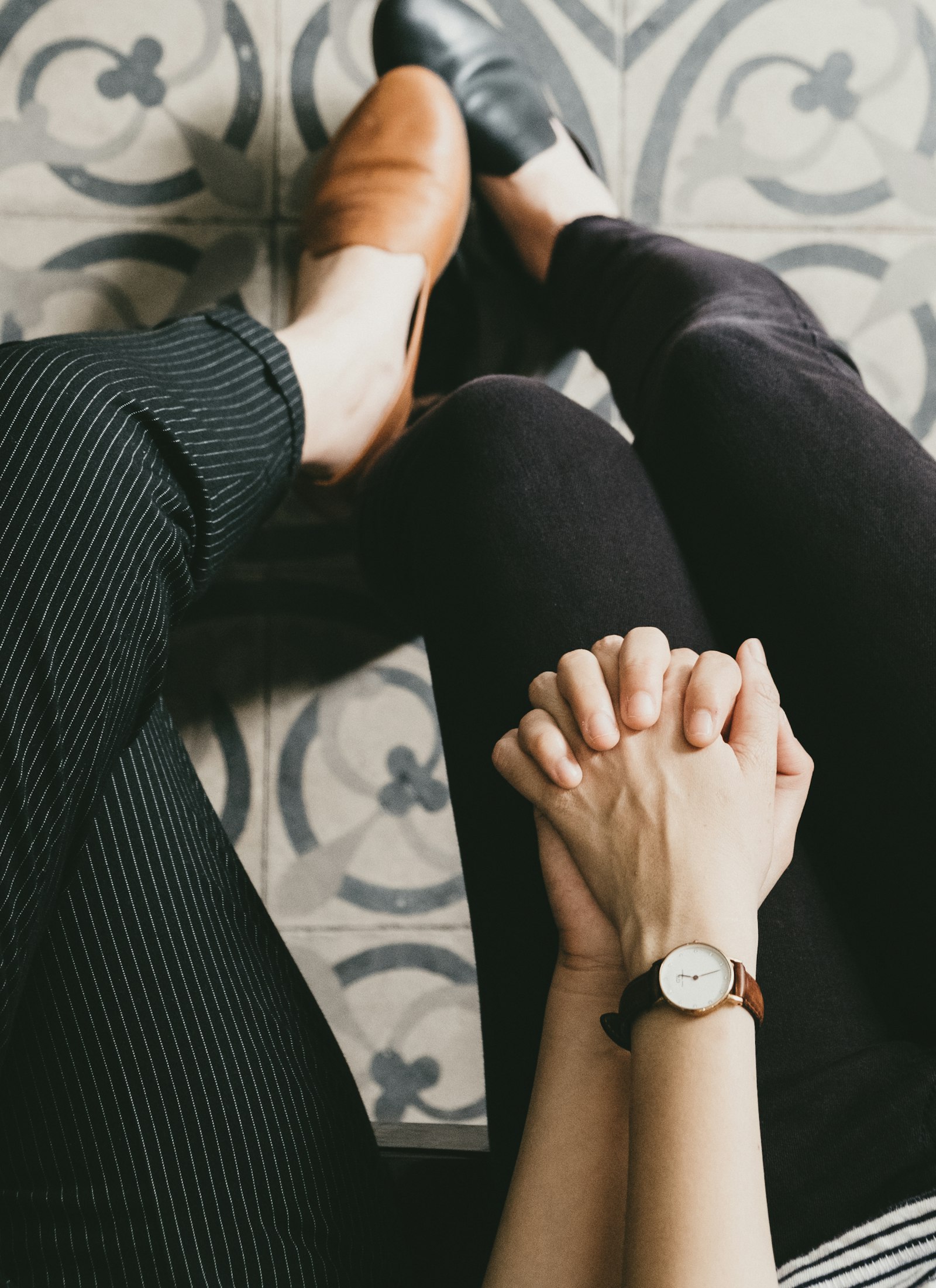 Couple holding hands while seated and working through trust repair in counseling