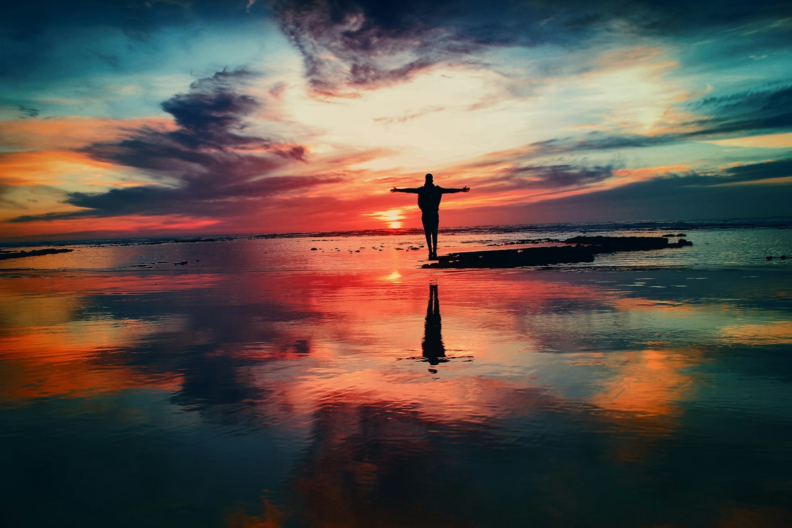 Person standing alone by the water while rebuilding a sense of self