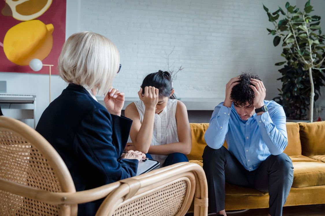 Couple talking with a therapist during a relationship counseling session