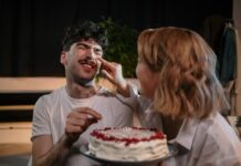 Couple celebrating a birthday together with a cake