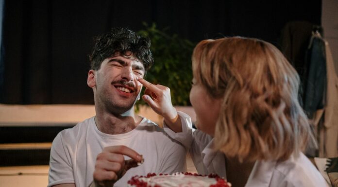 Couple celebrating a birthday together with a cake