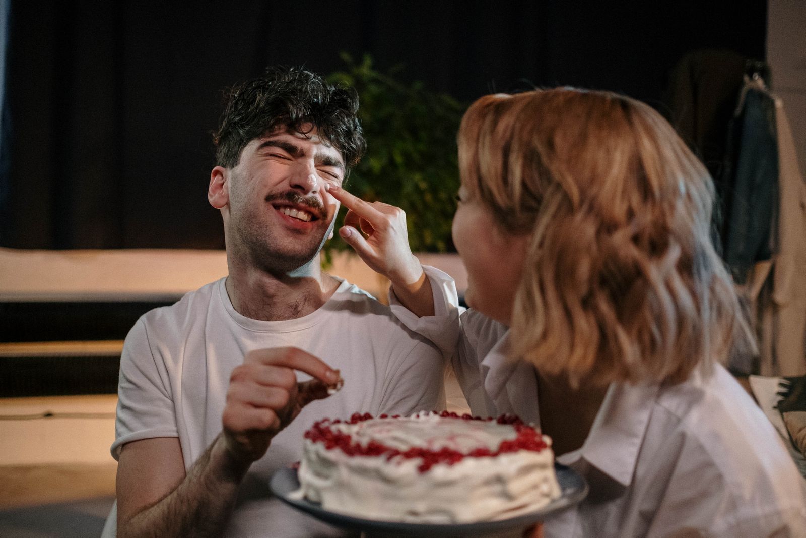 Couple celebrating a birthday together with a cake
