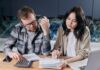 Couple discussing joint and separate bank accounts at home