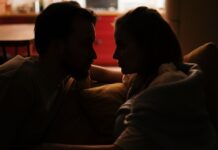 Couple discussing household lighting habits at home