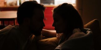Couple discussing household lighting habits at home