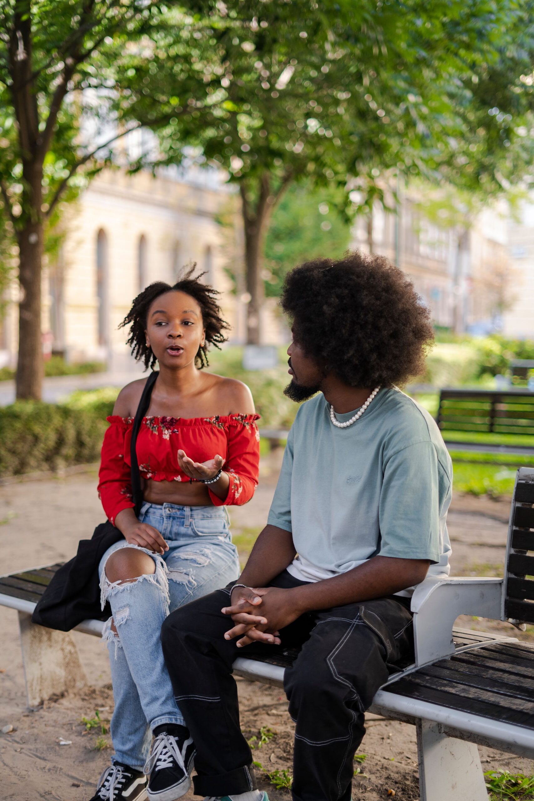 Couple discussing public affection boundaries on a park bench