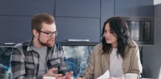 Couple discussing shared decisions at a kitchen table