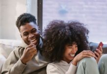 Couple discussing social media privacy boundaries while looking at a phone