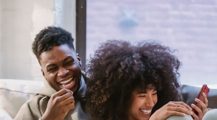 Couple discussing social media privacy boundaries while looking at a phone