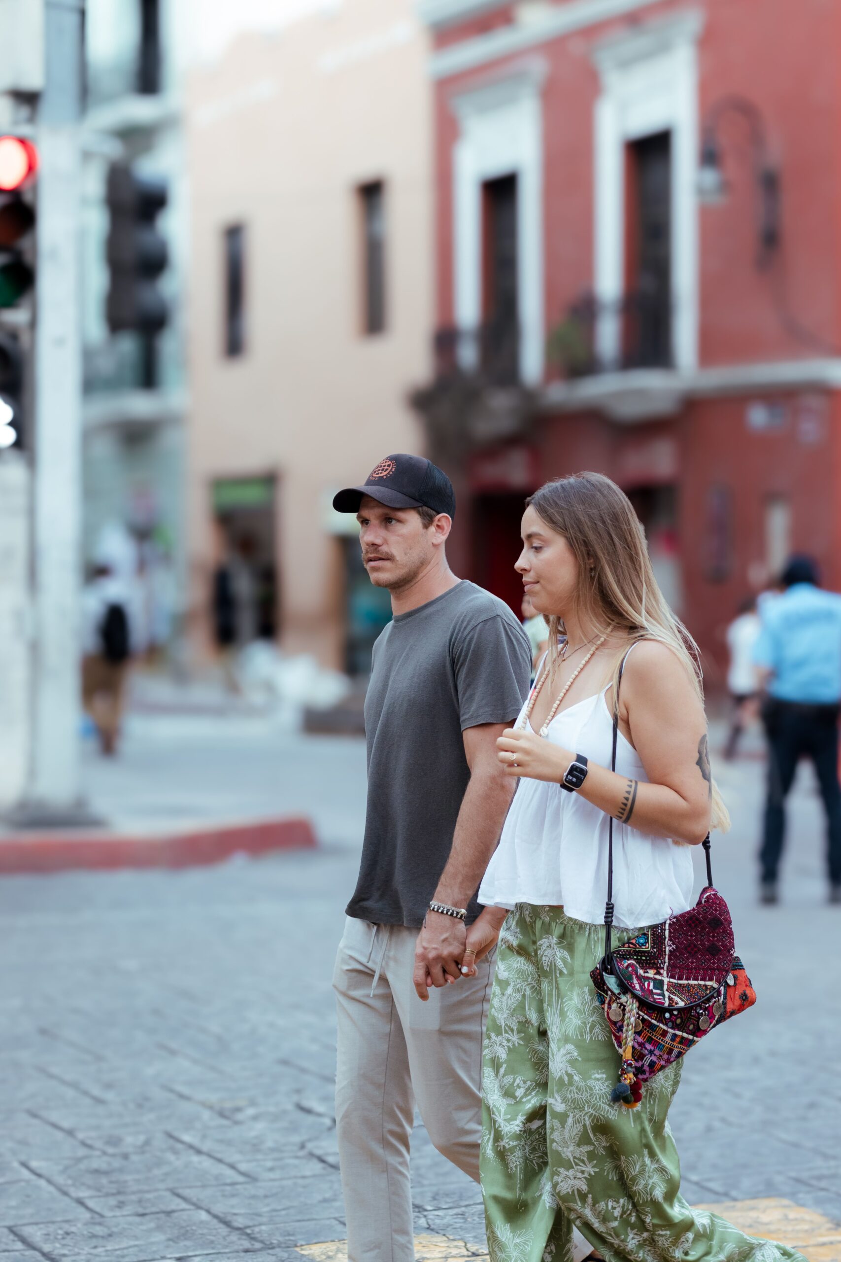 Couple holding hands while walking together in public