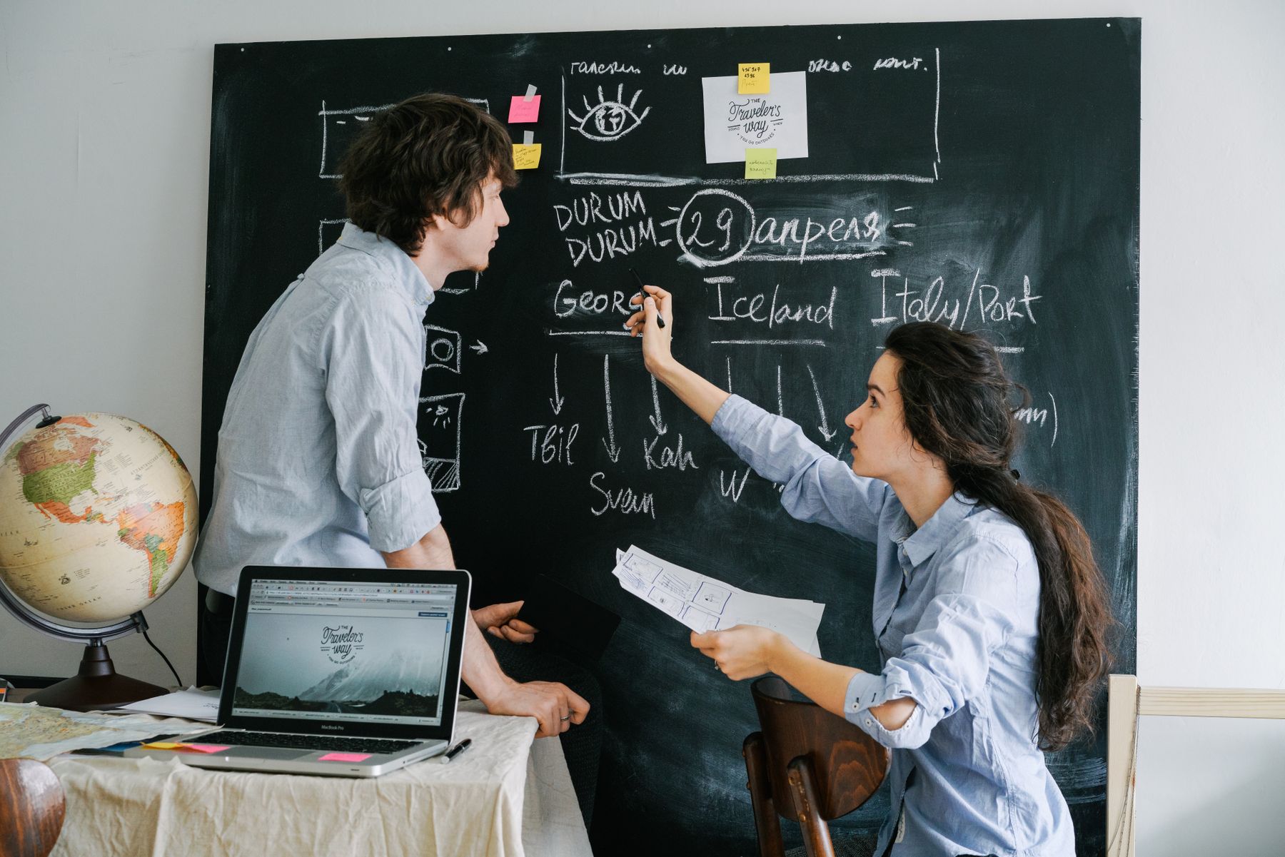 Couple comparing ideas while planning a vacation itinerary