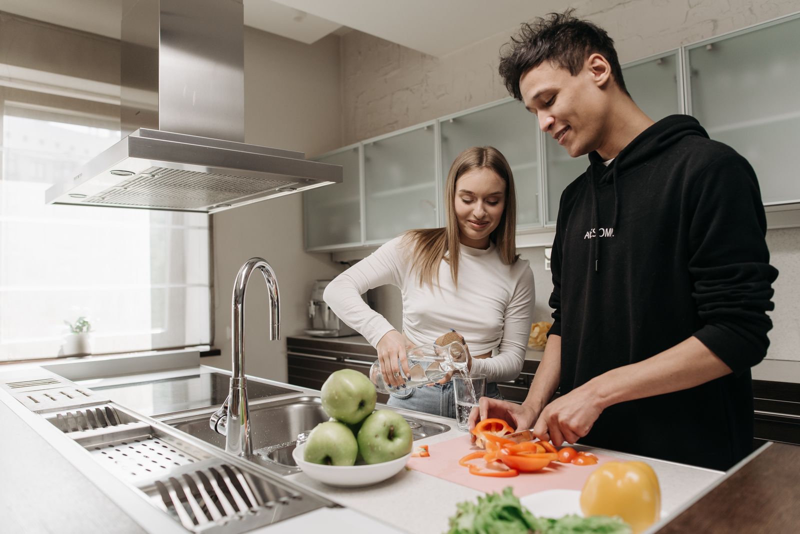 Couple preparing a customizable shared meal in their kitchen