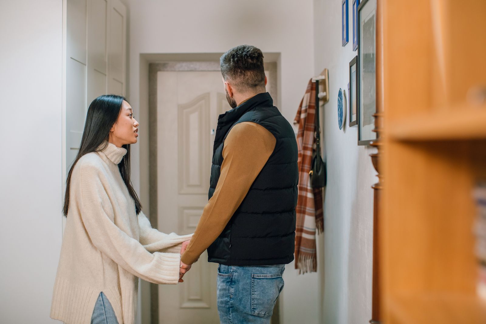 Couple holding hands while reconnecting after a political argument