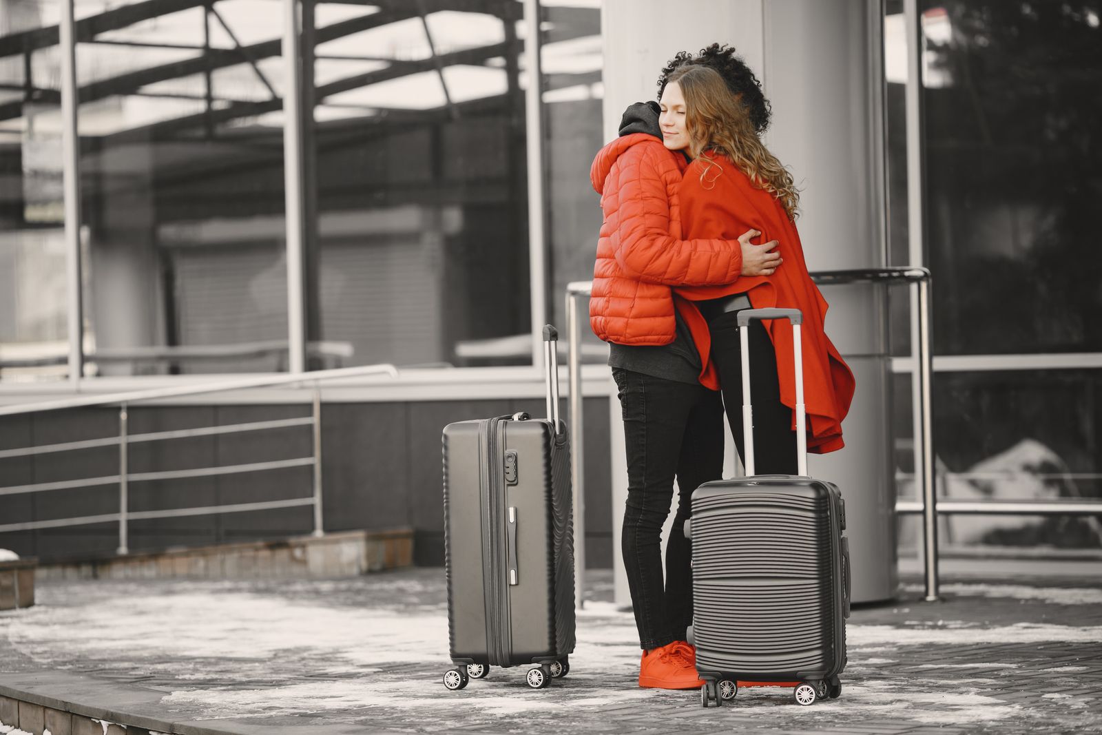 Couple embracing with luggage after time apart for work travel