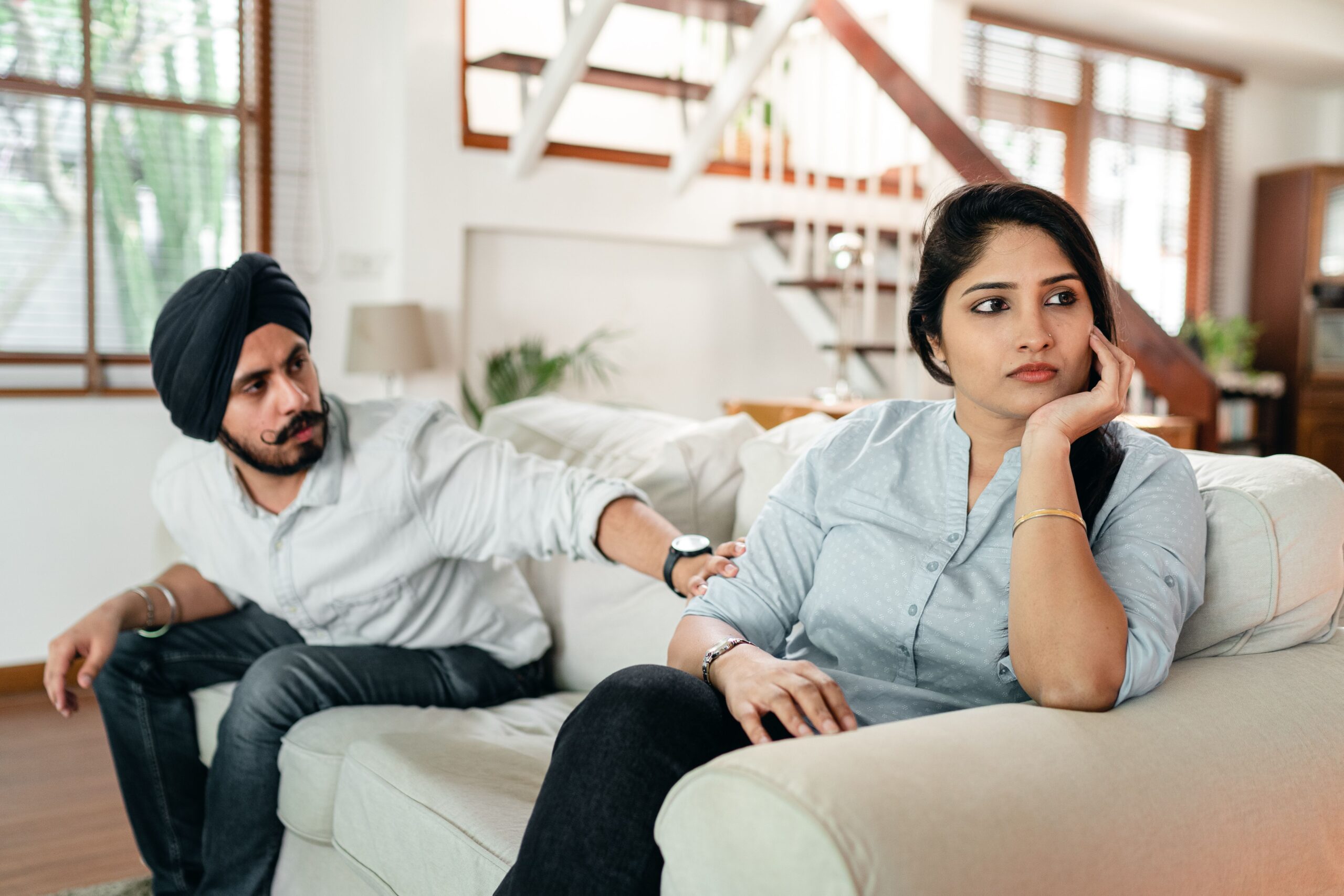Couple talking about repeated canceled plans at home