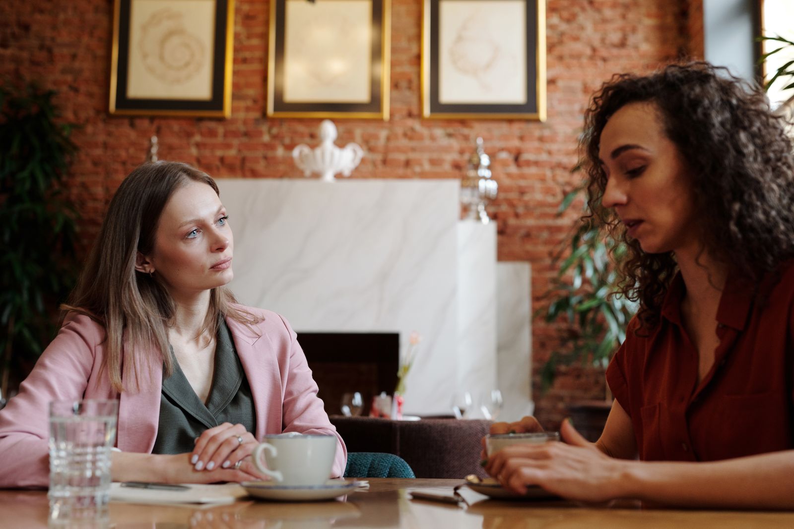 Friends having a private conversation over coffee about a relationship problem