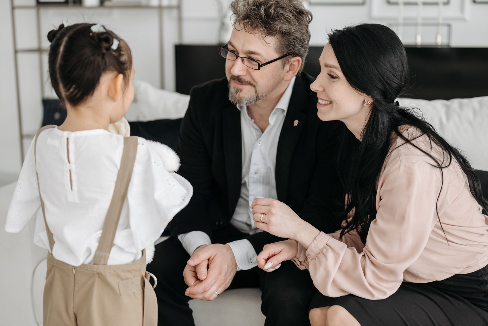 Couple listening to their child while discussing family rules at home