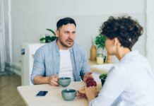 When Your Partner Is Always Late: How to Address Chronic Lateness Without Parenting Each Other Couple having a serious conversation about repeated lateness