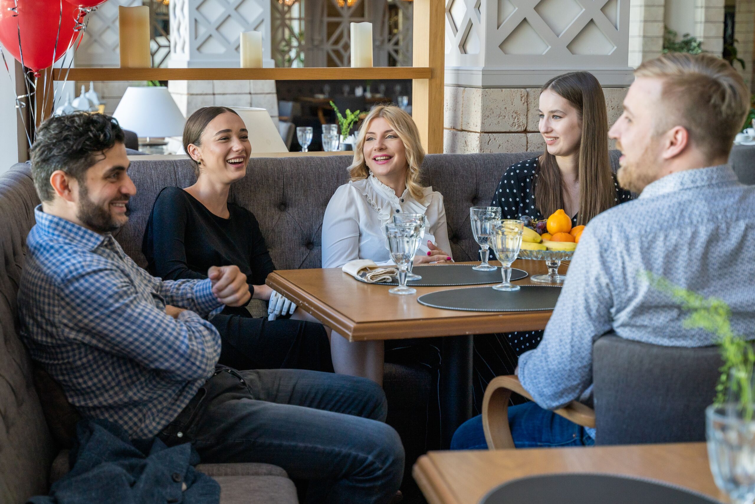 Friends talking together at a restaurant table