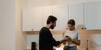 Couple discussing access to private text messages on a phone