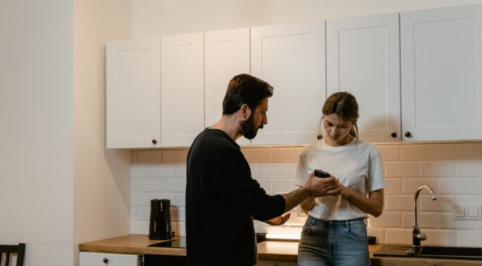 Couple discussing access to private text messages on a phone