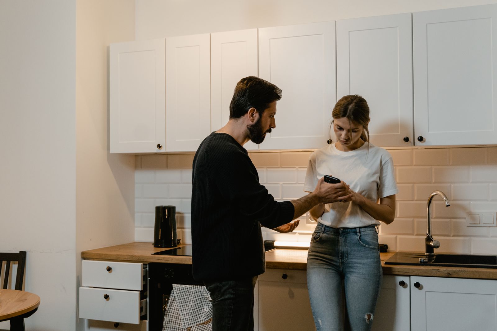 Couple discussing access to private text messages on a phone