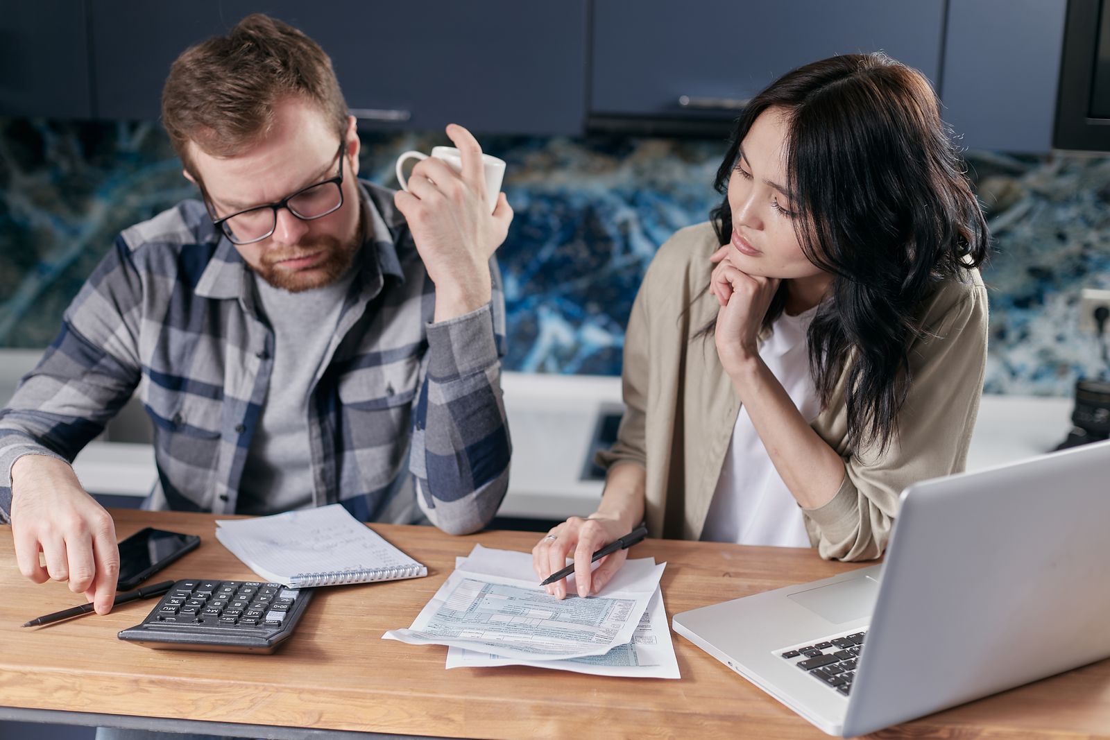 Partners reviewing household finances together at a table