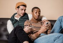 How to Set Phone Boundaries in a Relationship Without Policing Each Other Couple sitting together on a sofa while each uses a smartphone