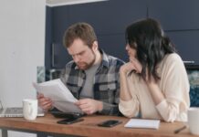 Engaged couple calmly reviewing documents together at home