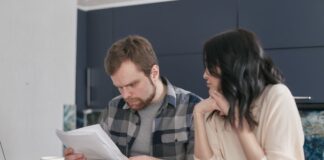 Engaged couple calmly reviewing documents together at home