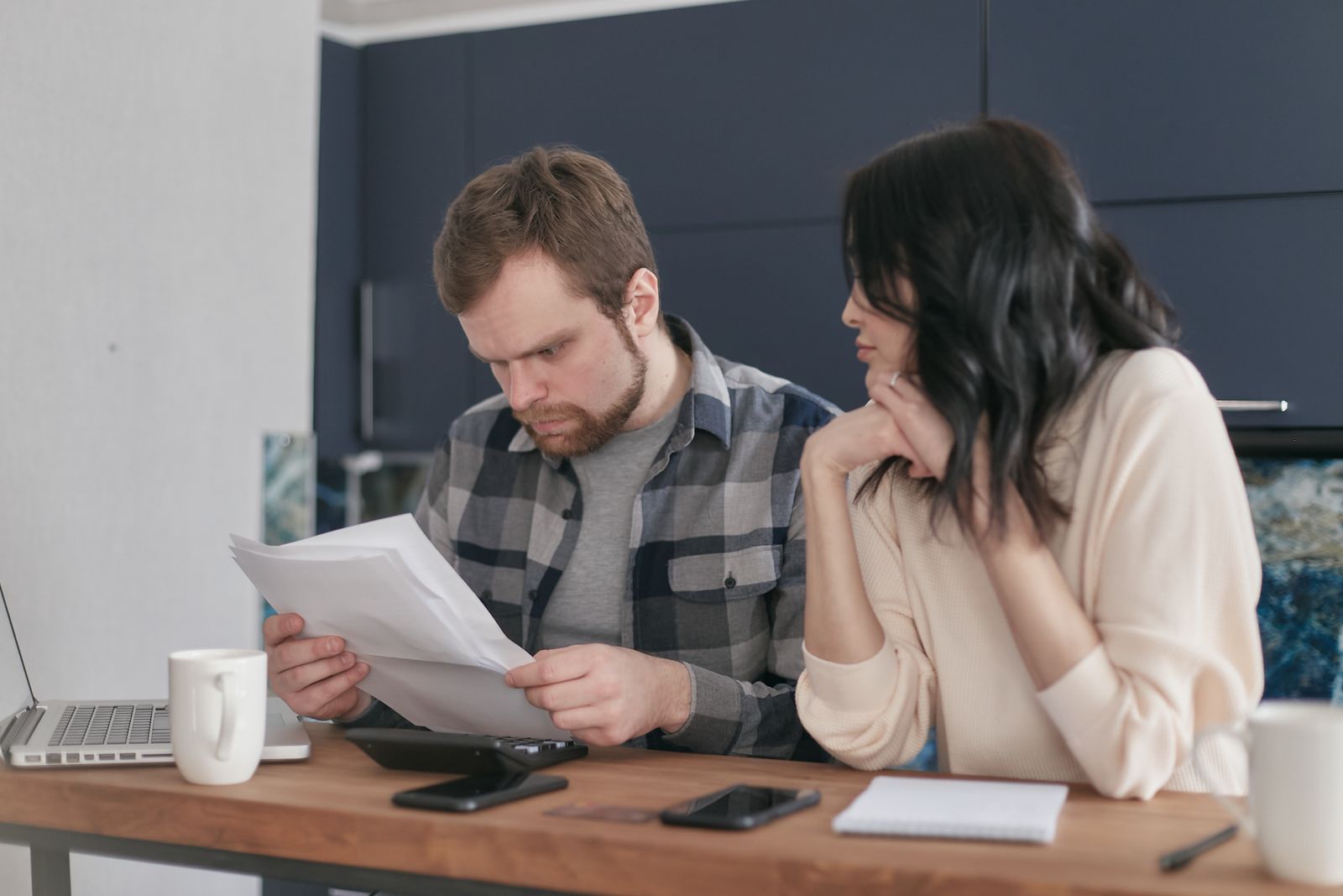 Engaged couple calmly reviewing documents together at home