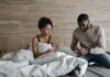 Spouse caregiver comforting an unwell partner at home
