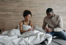 Spouse caregiver comforting an unwell partner at home