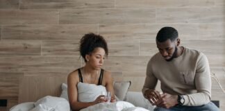Spouse caregiver comforting an unwell partner at home