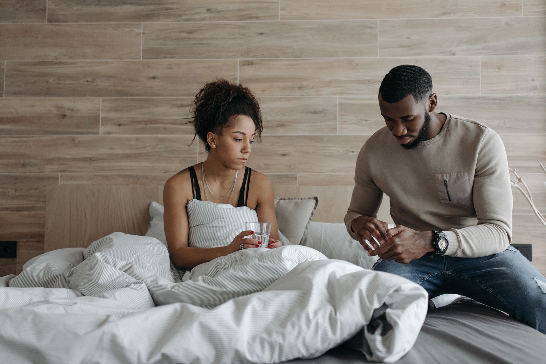 Spouse caregiver comforting an unwell partner at home