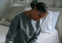 Partner offering quiet comfort to a grieving spouse at home